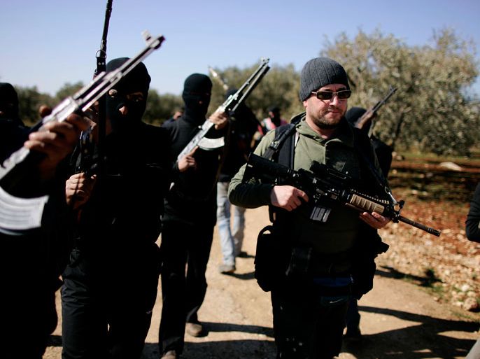 Syrian rebels, headed by their leader nick named " Abu Suleiman" (R) patrol and set up check-points in the north of northern Syria's Idlib region, on March 18, 2012