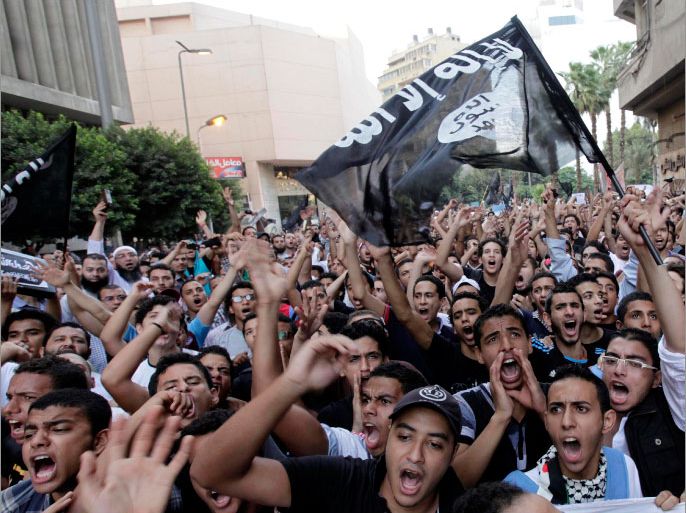 People shout slogans in front of the U.S. embassy in Cairo, during a protest against what they said was a film being produced in the United States that was insulting to the Prophet Mohammad, September 11, 2012. Egyptian protesters scaled the walls of the U.S. embassy on Tuesday, tore down the American flag and burned it during the protest, and in place of the U.S. flag, the protesters tried to raise a black flag with the words "There is no God but God, and Mohammad is his messenger", a Reuters witness said. REUTERS/Mohamed Abd El Ghany (EGYPT - Tags: CIVIL UNREST POLITICS RELIGION)