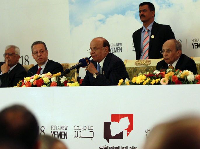 Sanaa, -, YEMEN : Yemeni President Abdrabuh Mansur Hadi (C) gives a speech during the opening of a national dialogue conference in Sanaa on March 18, 2013 . Hadi warned Yemenis against the use of force to express political views, as he opened a national dialogue to pave the way for the drafting of a new constitution and the staging of elections. AFP PHOTO/ MOHAMMED HUWAIS