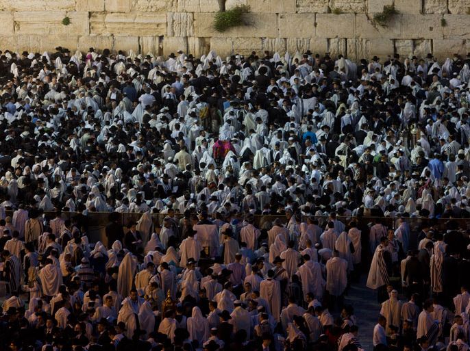 Thousands of religious Jews at sun rise at the Western Wall, Judaism's holiest site, as they complete studying and reading the Torah on the Jewish holiday of Shavuot in Jerusalem's Old City, Israel, 15 May 2013. Shavuot commemorates the anniversary of the day God gave the Torah to the entire nation of Israel assembled at Mount Sinai. It is a time of study for religious Jews who stay up through the night reading the Torah. EPA/JIM HOLLANDER