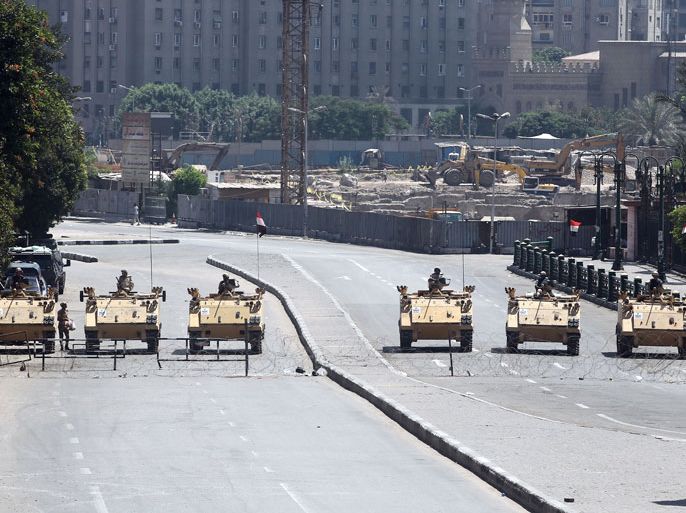 epa03834474 Egyptian army soldiers in armored vehicles block a road to Tahrir Square in Cairo, Egypt, 23 August 2013. Egyptian Islamist and secular groups were planning major demonstrations on 23 August, a day after toppled president Hosny Mubarak was released from prison and placed under house arrest. The secular April 6 Youth Movement, which led the uprising that forced Mubarak to step down in February 2011, were planning rallies to protest his release, which they have condemned as a 'deviation from the course of the revolution.' Mubarak still faces a retrial on charges of killing protesters during the uprising that ended his 30-year rule. Supporters of ousted president Mohammed Morsi were also planning marches nationwide in what they called the 'Friday of Martyrs' following the weekly noon prayers. EPA/KHALED ELFIQI