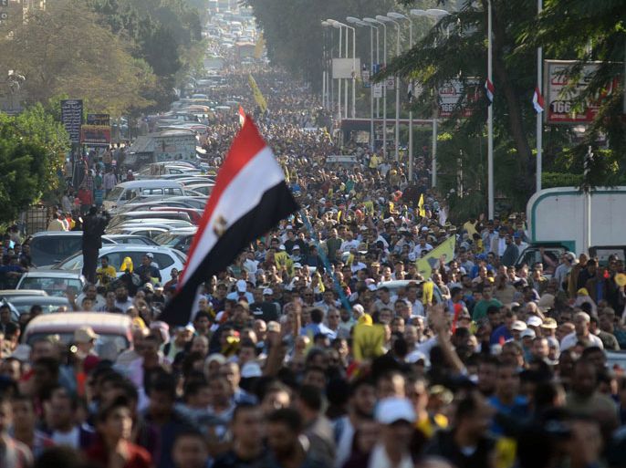 Supporters of ousted president Mohamed Morsi and the Muslim brotherhood march through the streets of Cairo's eastern Nasr City district on November 22, 2013. A young boy was killed as supporters and opponents of ousted president Mohamed Morsi fought in Suez city, and police fired tear gas elsewhere to quell disturbances, officials said. Confrontations came as pro-Morsi groups called for a week of anti-military demonstrations under the slogan "Massacre of the Century." AFP PHOTO/MOHAMED EL-SHAHED