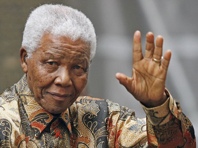 shows former South African president Nelson Mandela waving to
