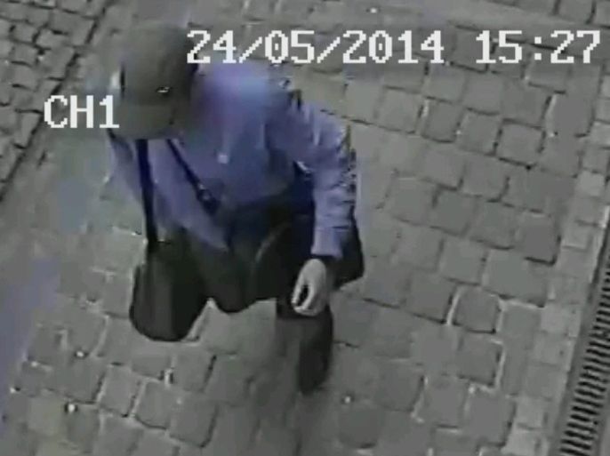 In this hand out photo distributed on Sunday, May 25, 2014 by the Belgian Federal Police, a surveillance camera shows the suspected killer, walking along, near the Jewish museum in Brussels, Saturday, May 24, 2014. Police stepped up security at Jewish institutions, schools and synagogues after three people were killed and one seriously injured in a spree of gunfire at the Jewish Museum in Brussels on Saturday. (AP Photo/Belgian Federal Police, hand out)