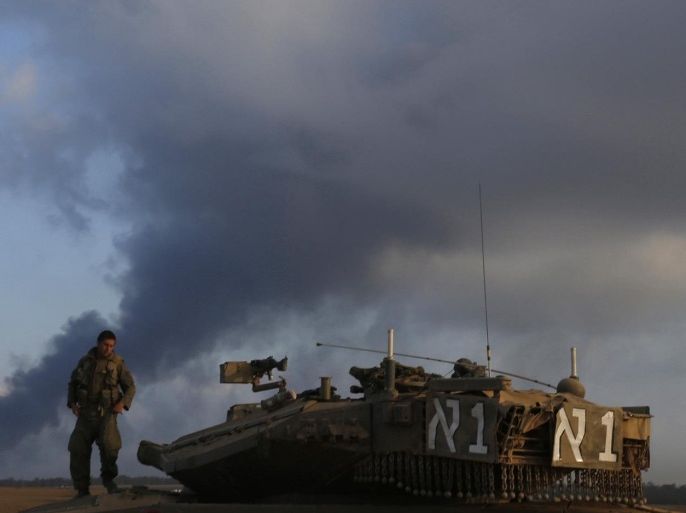 An Israeli soldier stand atop a tank outside the Gaza Strip July 31, 2014. Israeli Prime Minister Benjamin Netanyahu, facing international alarm over a rising civilian death toll in Gaza, said on Thursday he would not accept any ceasefire that stopped Israel completing the destruction of militants' infiltration tunnels. Gaza officials say at least 1,372 Palestinians, most of them civilians, have been killed in the battered territory and nearly 7,000 wounded. Fifty-six Israeli soldiers have been killed in Gaza clashes and more than 400 wounded. Three civilians have been killed by Palestinian shelling in Israel. REUTERS/Baz Ratner (ISRAEL - Tags: CIVIL UNREST MILITARY POLITICS CONFLICT)