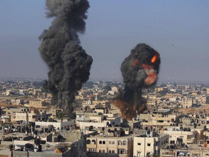 Smoke and flames are seen following what police said was an Israeli air strike in Rafah in the southern Gaza Strip July 9, 2014. At least 23 people were killed across Gaza, Palestinian officials said on Wednesday, by a bombardment Israel said may be just the start of a lengthy offensive against Islamist militants whose rockets struck deeper than ever before into Israel. REUTERS/Stringer (GAZA - Tags: POLITICS CIVIL UNREST TPX IMAGES OF THE DAY)
