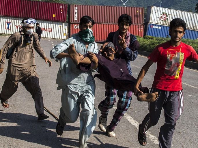 Supporters of Tahir ul-Qadri, Sufi cleric and leader of political party Pakistan Awami Tehreek (PAT), carry an injured fellow protester during the Revolution March in Islamabad August 31, 2014. Thousands of protesters massed outside the residence of Pakistani Prime Minister Nawaz Sharif on Saturday to demand he step down, after efforts to find a negotiated solution to the country's political crisis failed.Pakistan has been gripped by unrest for more than two weeks, with protest leaders Imran Khan and Tahir ul-Qadri saying they will not back back down unless Prime Minister Nawaz Sharif resigns. On Saturday Sharif once again said he would not go. REUTERS/Zohra Bensemra (PAKISTAN - Tags: POLITICS CIVIL UNREST)