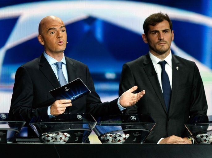 UEFA General Secretary Gianni Infantino, left, speaks as Real Madrid Iker Casillas looks on, during the UEFA Champions League draw at the Grimaldi Forum, in Monaco, Thursday, Aug. 28, 2014. (AP Photo/Claude Paris)