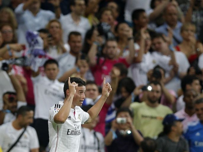 Real Madrid's James Rodriguez from Colombia celebrates after scoring a goal against Atletico Madrid during a Spanish Super Cup soccer match at Santiago Bernabeu stadium in Madrid, Spain, Tuesday, Aug. 19, 2014 . (AP Photo/Daniel Ochoa de Olza)