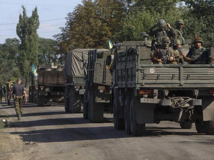 A Ukrainian military convoy is seen at a checkpoint in Luhansk region August 20, 2014. REUTERS/Valentyn Ogirenko (UKRAINE - Tags: CONFLICT CIVIL UNREST)