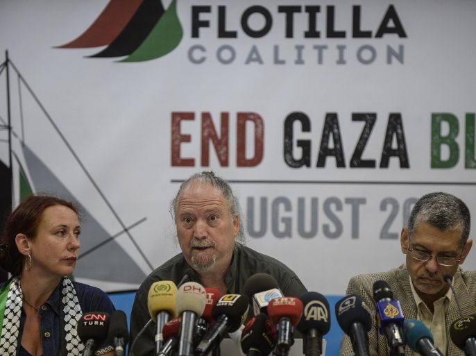 A member of the Freedom Flotilla Coalition Dror Feiler (C) speaks during a press conference on August 12, 2014, in Istanbul. A Turkish aid group said on August 12, 2014 it would send a new flotilla of ships to break Israel's siege of Gaza, four years after the deadly storming of its vessel by Israeli commandos. The Humanitarian Relief Foundation (IHH), which organised the first flotilla, said in a statement that activists from 12 countries had met in Istanbul and taken the decision to send the ships 'in the shadow of the latest Israeli aggression on Gaza'. AFP PHOTO/BULENT KILIC