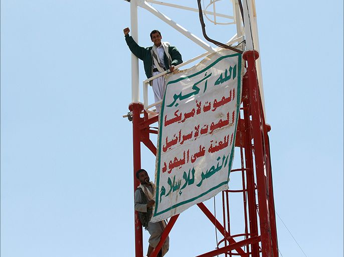 Yemeni Shiite Huthi anti-government rebels celebrate near a banner they hanged on a pole at an army base which they captured without resistance just hours before the signing a UN-brokered peace agreement on September 22, 2014 in the Yemeni capital, Sanaa. The hard-won deal, signed the day before by the president and all the main political parties, is intended to end a week of deadly fighting in Sanaa between the rebels and their opponents, and put the country's troubled transition back on track. The banner reads in Arabic: "God is the greatest... Death to America, death to Israel, cursed be the Jews, victory for Islam". AFP