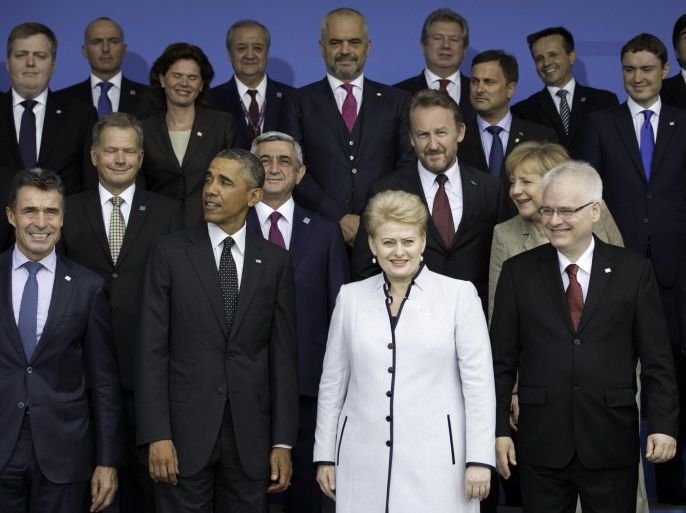 From front left, NATO Secretary General Anders Fogh Rasmussen, U.S. President Barack Obama, Lithuanian President Dalia Grybauskaite and Croatian President Ivo Josipovic pose for a group photo during a NATO summit at the Celtic Manor Resort in Newport, Wales on Thursday, Sept. 4, 2014. In a two-day meeting leaders will discuss, among other issues, the situation in Ukraine and Afghanistan. (AP Photo/Jon Super)