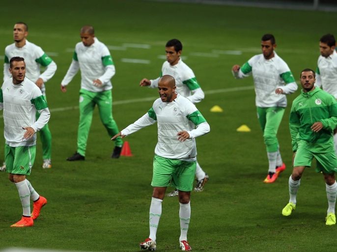 Algerian players Hassan Yebda (L) Madjid Bougherra (C) and Mehdi Lacen (R) during a training session of the Algerian national soccer team at the stadium Estadio Beira-Rio in Porto Alegre, Brazil, 29 June 2014. Germany will face Algeria in their FIFA World Cup 2014 round of sixteen match on 30 June 2014 in Porto Alegre. (RESTRICTIONS APPLY: Editorial Use Only, not used in association with any commercial entity - Images must not be used in any form of alert service or push service of any kind including via mobile alert services, downloads to mobile devices or MMS messaging - Images must appear as still images and must not emulate match action video footage - No alteration is made to, and no text or image is superimposed over, any published image which: (a) intentionally obscures or removes a sponsor identification image; or (b) adds or overlays the commercial identification of any third party which is not officially associated with the FIFA World Cup) EPA/MOHAMED MESSARA