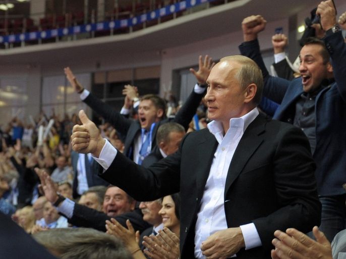 Russian President Vladimir Putin, foreground right, gestures, as he attends the Judo World Cup in the city of Chelyabinsk in Siberia, Russia, on Sunday, Aug. 31, 2014. Putin is calling on Ukraine to immediately start talks on a political solution to the crisis in eastern Ukraine, including discussing statehood. (AP Photo/RIA Novosti, Alexei Druzhinin, Presidential Press Service)