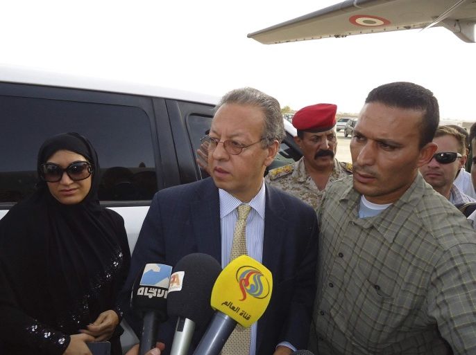 United Nation's special envoy to Yemen, Jamal Benomar (C), speaks to reporters as he boards a military plane in Saada, a stronghold of the Shi'ite Houthi group, September 19, 2014. Armed Shi'ite rebels shelled Yemen's state-run television building on Friday as they advanced into Sanaa, sending hundreds fleeing their homes in a dramatic escalation of violence after weeks of fighting and protests, officials and residents said. A senior government official told Reuters the army was following a "policy of restraint" to give U.N. special envoy Benomar a chance to find a way out of the conflict. Benomar had a three-hour meeting with Houthi leader Abdulmalek al-Houthi in Saada province on Wednesday which he described as "constructive and positive", state news agency Saba reported. REUTERS/Naiyf Rahma (YEMEN - Tags: POLITICS CIVIL UNREST)