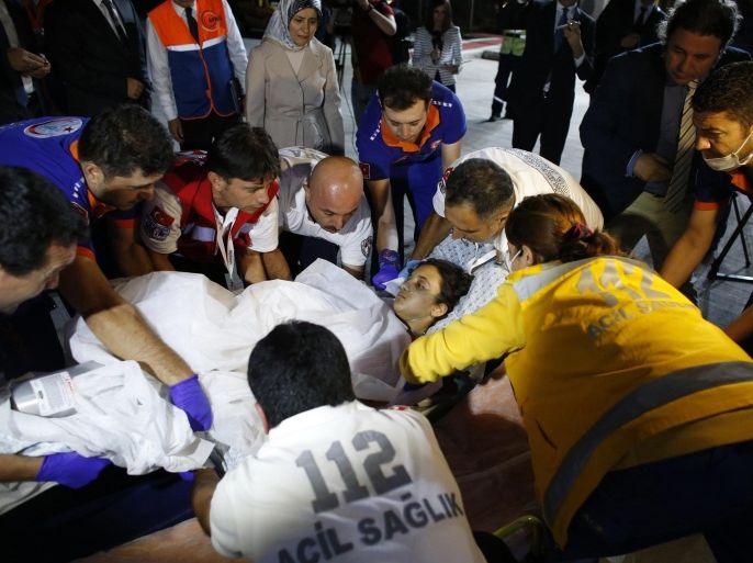 A Palestinian, who was injured in clashes in the Gaza strip, is carried on a stretcher to an ambulance after the arrival of a group of injured Palestinians at Ankara's Esenboga airport, early August 11, 2014. Four wounded Palestinians from the Gaza Strip arrived in the Turkish capital early on Monday after being flown in for medical treatment, with more expected, in a move announced by prime minister and president-elect Tayyip Erdogan. "In the first stage we plan to bring to Turkey, and treat, maybe 200 patients," Foreign Minister Ahmet Davutoglu said, adding that further patients would be brought by planes in groups of around 40 after agreeing the move in talks with Israel and Egypt. REUTERS/Umit Bektas (TURKEY - Tags: POLITICS CIVIL UNREST CONFLICT HEALTH TPX IMAGES OF THE DAY)