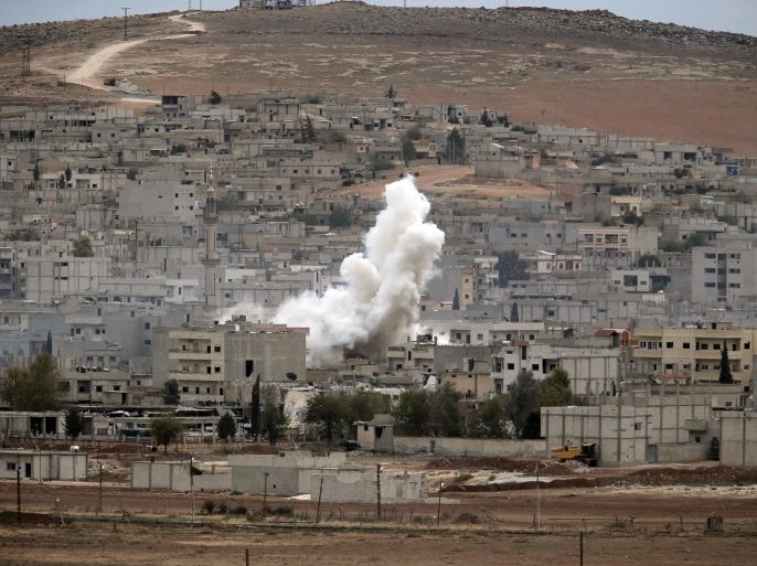 Smoke from a fire rises following a strike in Kobani, Syria, during fighting between Syrian Kurds and the militants of Islamic State group, as seen from a hilltop on the outskirts of Suruc, at the Turkey-Syria border, Sunday, Oct. 19, 2014. Kobani, also known as Ayn Arab, and its surrounding areas, has been under assault by extremists of the Islamic State group since mid-September and is being defended by Kurdish fighters. (AP Photo/Lefteris Pitarakis)