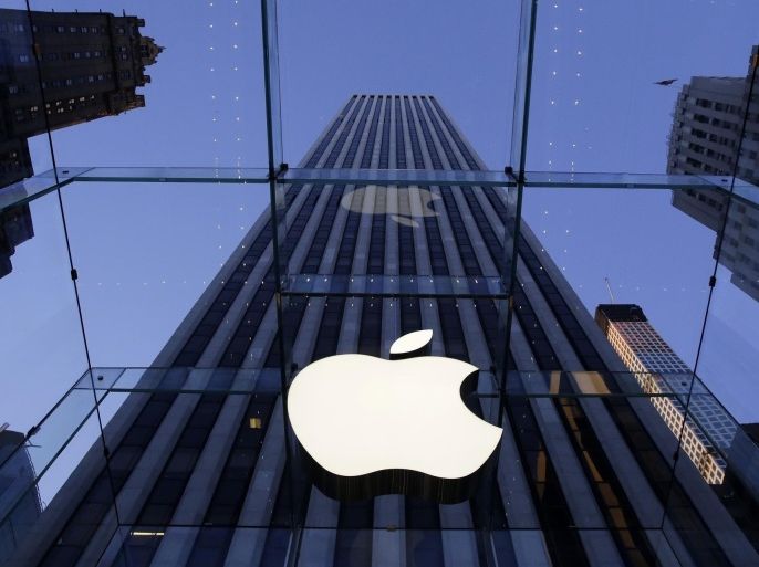 In this Sept. 5, 2014 photo, the Apple logo hangs in the glass box entrance to the company's Fifth Avenue store, in New York. Apple on Wednesday, Oct. 8, 2014 sent invites to an Oct. 16 event during which it’s expected to show off new models of its popular iPad and an update to its Mac OS system.(AP Photo/Mark Lennihan)