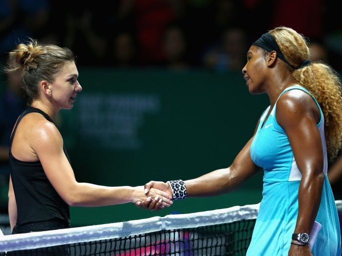 SINGAPORE - OCTOBER 22: Simona Halep of Romania shakes hands at the net after her straight sets victory against Serena Williams of the United States in their round robin match during the BNP Paribas WTA Finals at Singapore Sports Hub on October 22, 2014 in Singapore.