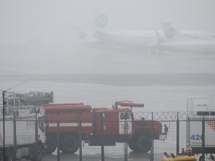 A fire truck is seen at the Vnukovo-3 Business Aviation Center at Moscow's Vnukovo airport, October 21, 2014. The chief executive of French oil major Total, Christophe de Margerie, was killed when a business jet collided with a snow plough during takeoff at Moscow's Vnukovo International Airport, the company and airport officials said. REUTERS/Maxim Shemetov (RUSSIA - Tags: DISASTER TRANSPORT)