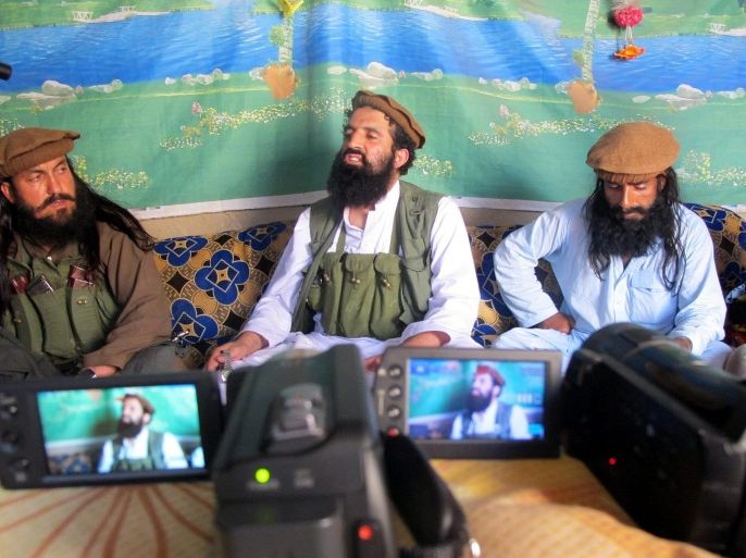 A picture made available on 15 October 2014 shows Shahidullah Shahid (C), the spokesman of Pakistani Talibans speaking to journalists at an undisclosed location near the Pak-Afghan border, 21 February 2014. Five Taliban commanders in Pakistan and their spokesman announced formal allegiance on 15 October to the Islamic State militant group, in a blow to al-Qaeda's dominance in the region. Spokesman Shahidullah Shahid said he had accepted the leadership of the Islamic State chief, Abu Bakr al-Baghdadi, whose group has taken over large swatches of territory in Iraq and Syria.