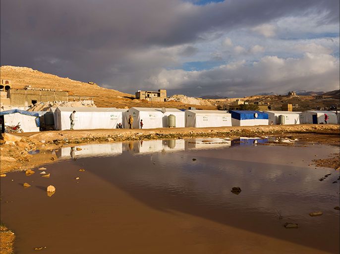 A large pool of water from a heavy rain is seen near tents at a Syrian refugee camp in the eastern Lebanese town of Arsal on October 23, 2014. With more than 1.1 million Syrian refugees, Lebanon has the most refugees per capita in the world, and the influx has created some resentment in a country of four million already facing economic and political challenges. AFP