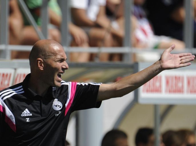 Former French football star and new coach of Real Madrid Castilla Zinedine Zidane gestures during the Spanish League B football match Real Madrid Castilla vs Atletico de Madrid at the Cerro del Espino stadium in Majadahonda, near Madrid on august 24, 2014. AFP PHOTO/ PEDRO ARMESTRE