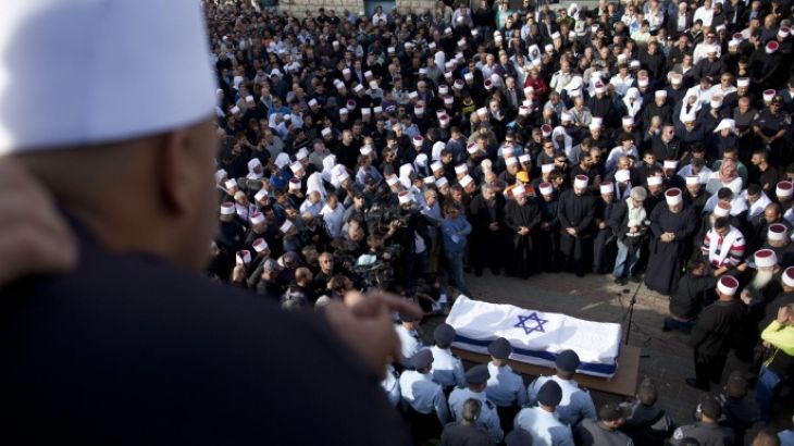 YANUH-JAT, ISRAEL - NOVEMBER 19: Druze men and relatives attend the funeral of Druze Israeli police officer Zidan Sif on November 19, 2014 Druze village of Yanuh-Jat, Israel. Sif, 30, died of his wounds on November 18, after two Palestinian cousins armed with meat cleavers and a gun stormed a Jerusalem synagogue during morning prayers, killing four rabbis.