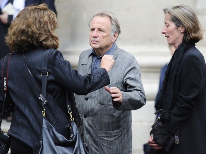 French philosopher Regis Debray (C) hugs an unidentified woman as he leaves Saint-Eustache church, after the funeral mass of late French doctor and neuroscientist, David Servan-Schreiber, on July 27, 2011 in Paris. Servan-Schreiber, who died at 50 on July 24, 2011, became an advocate of harnessing the body's own defenses to fight cancer after learning he had a brain tumor 20 years ago. His book 'Anticancer: A New Way of Life' sold 1 million copies and led to a sea change in how cancer was viewed and treated.