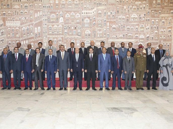Yemen's President Abd-Rabbu Mansour Hadi (front C) and newly appointed Prime Minister Khaled Bahah (7th L) pose for a group photo with the new cabinet after it was sworn-in at the Presidential Palace in Sanaa in this November 9, 2014 handout released by the country's Defence Ministry. REUTERS/Yemen's Defence Ministry/Handout via Reuters (YEMEN - Tags: POLITICS) ATTENTION EDITORS - NO SALES. NO ARCHIVES. FOR EDITORIAL USE ONLY. NOT FOR SALE FOR MARKETING OR ADVERTISING CAMPAIGNS. THIS IMAGE HAS BEEN SUPPLIED BY A THIRD PARTY. IT IS DISTRIBUTED, EXACTLY AS RECEIVED BY REUTERS, AS A SERVICE TO CLIENTS. REUTERS IS�UNABLE�TO INDEPENDENTLYVERIFY�THE AUTHENTICITY, CONTENT, LOCATION OR DATE OF THIS IMAGE.�