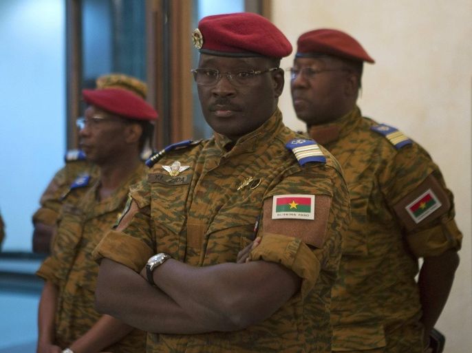 Burkina Faso Prime minister Yacouba Isaac Zida stands as an official reads the names of transitional government ministers in Ouagadougou November 23, 2014. REUTERS/Joe Penney (BURKINA FASO - Tags: POLITICS CIVIL UNREST MILITARY)