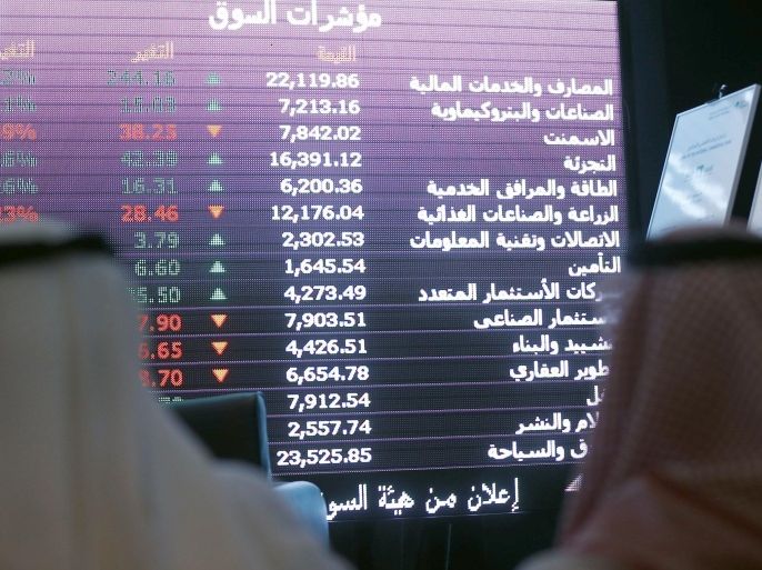 Saudi investors monitor stocks at the newly opened exchange market department at the National Commercial Bank (NCB) in Riyadh on November 12, 2014. NCB shares surged 10 percent in their first day of trading after the kingdom's largest public offering. It raised $6 billion and was oversubscribed 23 times. AFP PHOTO/FAYEZ NURELDINE