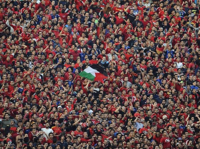 CAIRO, EGYPT - DECEMBER 06 : Fans of the Egypt's Al-Ahly chant slogans before the second leg of the CAF Confederation Cup final football match between Egypt's Al-Ahly and Ivory Coast's Sewe Sport at the Cairo Stadium in Cairo, Egypt on December 06, 2014.