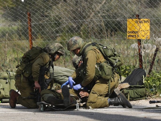 Wounded Israeli soldiers receive medical treatment after their army vehicle was hit by anti-tank missile, near the Har Dov area, on the Israeli-Lebanese border, 28 January 2015. An Israeli military vehicle was hit by an anti-tank missile near the border with Lebanon, the army said. Israeli emergency services said there were injuries in the incident. Israel responded by firing several rockets toward south-eastern Lebanon, according to a Lebanese security source. Israeli troops had been operating in the area, local media said, searching for possible tunnels dug by the Hezbollah militant group. Israel has been anticipating an attack from Hezbollah after it killed six fighters of the Iran-backed Shiite militant group in an air strike in Syria earlier this month.