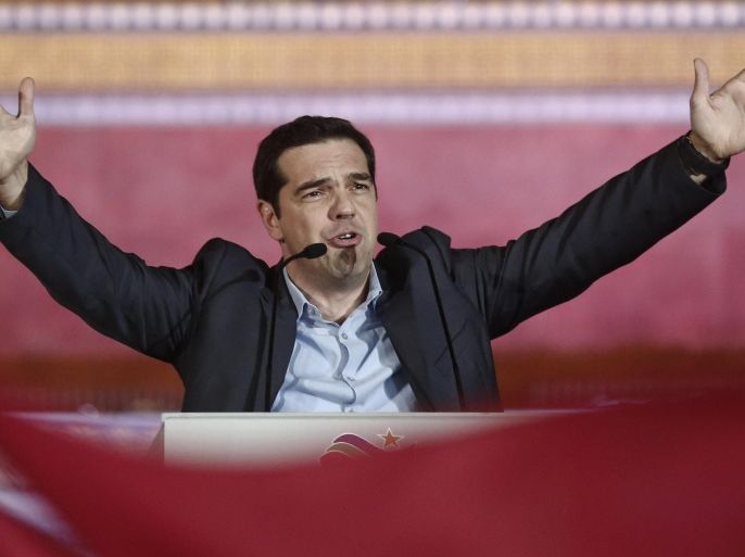 Leader of Syriza left-wing party Alexis Tsipras waves to his supporters outside Athens University Headquarters, Sunday, Jan. 25, 2015. A triumphant Alexis Tsipras told Greeks that his radical left Syriza party's win in Sunday's early general election meant an end to austerity and humiliation and that the country's regular and often fraught debt inspections were a thing of the past. "Today the Greek people have made history. Hope has made history," Tsipras said in his victory speech at a conference hall in central Athens. (AP Photo/Petros Giannakouris)