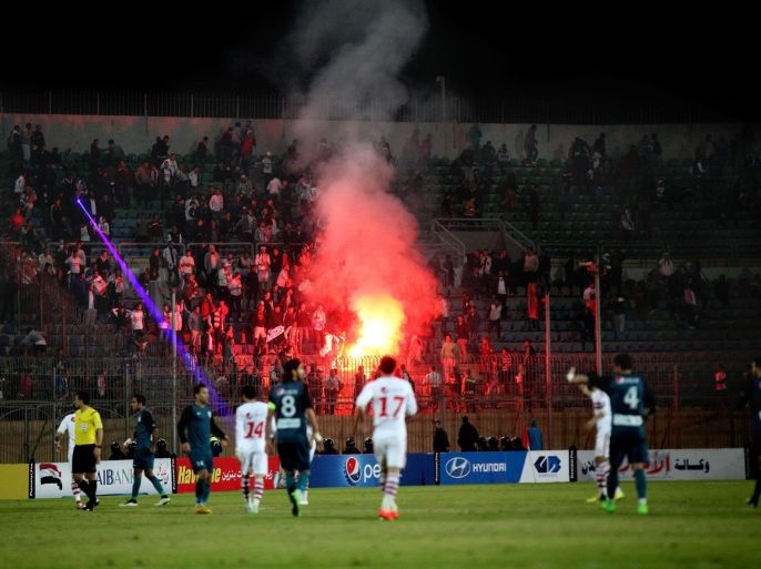 In this Sunday, Feb. 8, 2015 photo, Ultras White Knights soccer fans light flares during a match between Egyptian Premier League clubs Zamalek and ENPPI at the Air Defense Stadium in a suburb east of Cairo, Egypt. Egypt's Cabinet has indefinitely suspended the national soccer league after more than 20 fans were killed in a stampede and clashes with police outside the Cairo stadium. (AP Photo/Ahmed Abd El-Gwad, El Shorouk Newspaper) EGYPT OUT