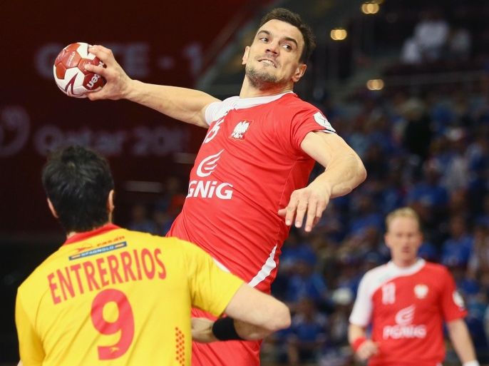 DOHA, QATAR - FEBRUARY 01: Raul Enterrios of Spain (L) defends against Michal Jurecki of Poland (R)during the third place match between Poland and Spain in the Men's Handball World Championship at Lusail Multipurpose Hall on February 1, 2015 in Doha, Qatar.