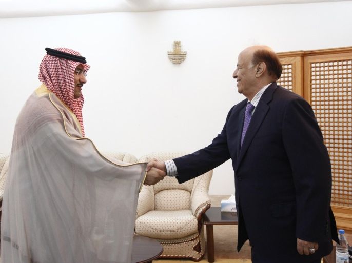 Yemen's President Abd-Rabbu Mansour Hadi (R) shakes hands with Saudi Arabia's ambassador to Yemen Mohammed Said al-Jaber ahead of a meeting in the southern port city of Aden February 28, 2015. Saudi Arabia has moved its ambassador to the southern city of Aden, an aide to President Hadi said on Thursday, in an apparent snub to the Shi'ite Houthi faction that has taken control of the capital Sanaa. Saudi Arabia joined Western states this month in evacuating its embassy in Sanaa following a power grab by the Iranian-backed northern Houthis, viewed with suspicion by the Gulf's mostly Sunni Muslim rulers. Al-Jaber's move to Aden, Yemen's economic hub, underlines Saudi Arabia's support for Hadi, who fled to the port city last week after the Houthis forced him to announce his resignation and held him under house arrest in Sanaa for a month. REUTERS/Stringer (YEMEN - Tags: POLITICS)