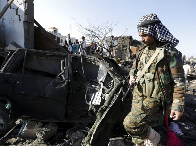 A Houthi fighter walks at the site of an air strike at a residential area near Sanaa Airport March 26, 2015. Saudi Arabia and Gulf region allies launched military operations including air strikes in Yemen on Thursday, officials said, to counter Iran-allied forces besieging the southern city of Aden where the U.S.-backed Yemeni president had taken refuge. REUTERS/Khaled Abdullah