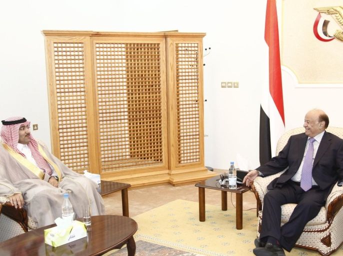 Yemen's President Abd-Rabbu Mansour Hadi (R) talks with Saudi Arabia's ambassador to Yemen Mohammed Said al-Jaber during a meeting in the southern port city of Aden February 28, 2015. Saudi Arabia has moved its ambassador to the southern city of Aden, an aide to President Hadi said on Thursday, in an apparent snub to the Shi'ite Houthi faction that has taken control of the capital Sanaa. Saudi Arabia joined Western states this month in evacuating its embassy in Sanaa following a power grab by the Iranian-backed northern Houthis, viewed with suspicion by the Gulf's mostly Sunni Muslim rulers. Al-Jaber's move to Aden, Yemen's economic hub, underlines Saudi Arabia's support for Hadi, who fled to the port city last week after the Houthis forced him to announce his resignation and held him under house arrest in Sanaa for a month. REUTERS/Stringer (YEMEN - Tags: POLITICS)