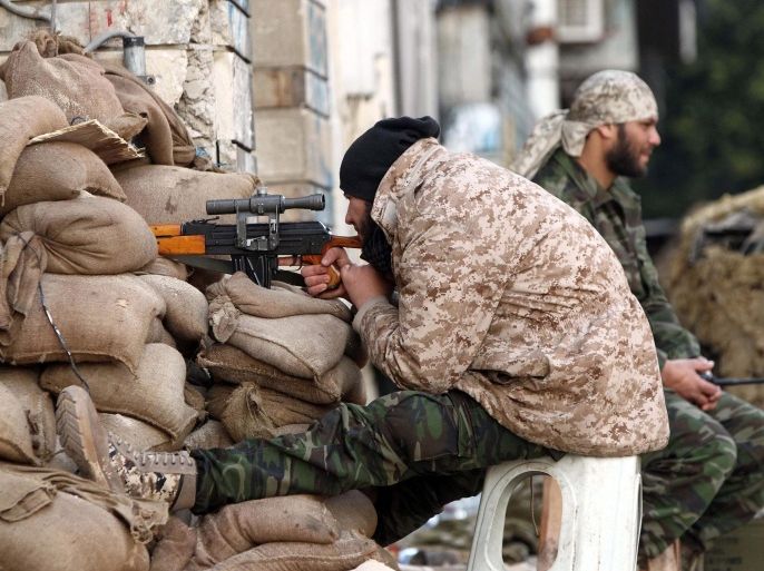 A Libyan soldier, loyal to Libya's internationally recognised government of Abdullah al-Thani and General Khalifa Haftar, monitors a street from his sniper nest in the eastern coastal city of Benghazi on February 28, 2015. Benghazi is one of the less stable areas of the North African state, which has been plunged into chaos since the 2011 revolution that toppled dictator Moamer Kadhafi. AFP PHOTO / ABDULLAH DOMA