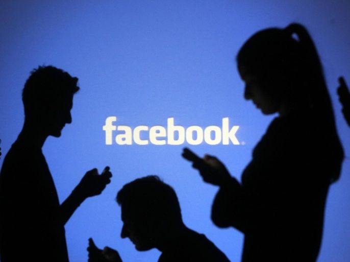 People are silhouetted as they pose with mobile devices in front of a screen projected with a Facebook logo, in this picture illustration taken in Zenica October 29, 2014. Facebook Inc said on Wednesday its revenue grew 49 percent in the final three months of 2014, as strength in mobile advertising helped the Internet social networking company beat Wall Street's revenue target. REUTERS/Dado Ruvic/Files (BOSNIA AND HERZEGOVINABUSINESS LOGO - Tags: BUSINESS SCIENCE TECHNOLOGY)