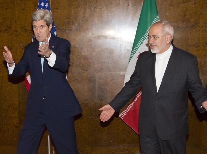 U.S. Secretary of State John Kerry (L) and his Iranian counterpart Mohammad Javad Zarif discuss seating arrangements for a meeting during a new round of nuclear negotiations in Montreux March 2, 2015. Kerry and Zarif held the first of what could amount to three days of meetings in Montreux about restraining the Iranian nuclear program in exchange for relief from economic sanctions. REUTERS/Evan Vucci/Pool (SWITZERLAND - Tags: POLITICS ENERGY)
