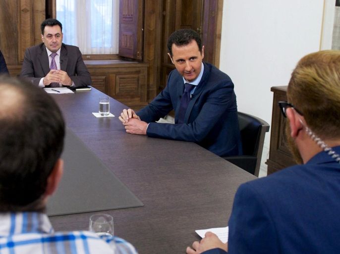 A handout picture made available 27 March 2015 by the Syrian Arab News Agency (SANA) shows Syrian President, Bashar al-Assad (2 - R), during an interview with Russian media, Damascus, Syria, 25 March 2015. During the interview al-Assad claimed that he had so far had no talks with the US regarding a solution to the ongoing civil war in Syria but hailed talks in Russia scheduled for 06-09 April as a positive step, despite suggestions he would not be attending, further adding that the crisis affecting Syria, as in the Ukraine, was a political plot to weaken his long term supporter, Russia. EPA/SYRIAN ARAB NEWS AGENCY / HANDOUT