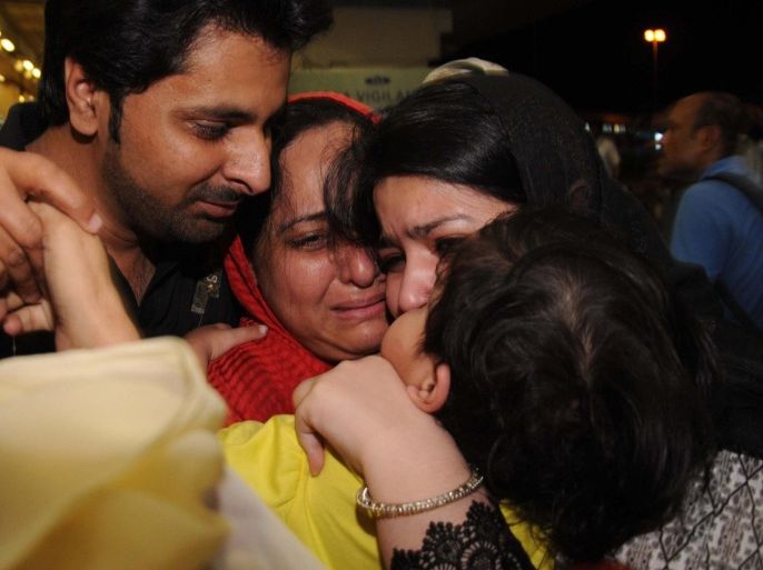 A Pakistani family, evacuated from Yemen, is greeted by relatives on their arrival in Jinnah International Airport in Karachi on March 30, 2015. Pakistan evacuated more than 500 of its citizens from Yemen by jumbo jet and sent a naval frigate to rescue others stranded in the war-torn country, officials said. AFP PHOTO / Rizwan TABASSUM