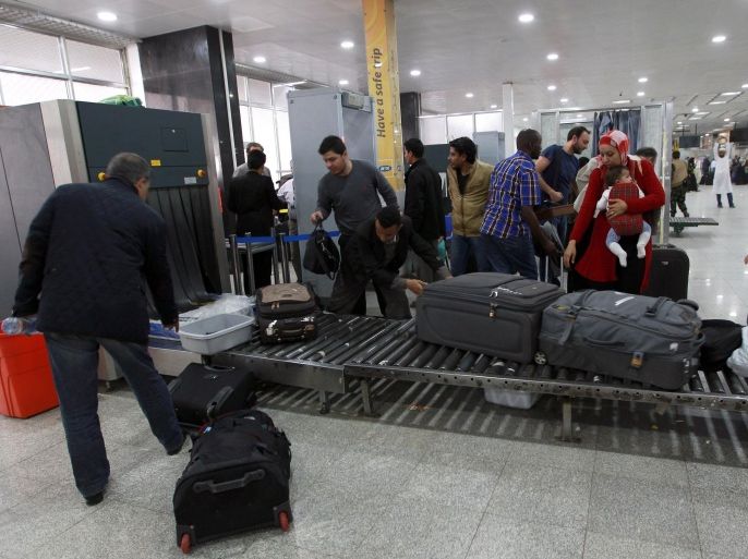 Travelers pass through security at Sanaa International Airport as hundreds of foreigners were evacuated from the Yemeni capital due to security reasons on March 28, 2015 after the third day of Saudi-led coalition airstrikes against Shiite Huthi rebels. AFP PHOTO / MOHAMMED HUWAIS