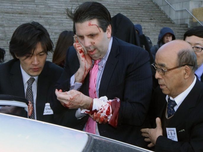 Injured U.S. Ambassador to South Korea Mark Lippert, center, gets into a car to leave for a hospital in Seoul, South Korea, Thursday, March 5, 2015. Lippert was attacked by a man wielding a razor and screaming that the rival Koreas should be unified, South Korean police and media said Thursday. His injuries weren't immediately clear and he was taken to a hospital for treatment. (AP Photo/Yonhap, Kim Ju-Sung) KOREA OUT
