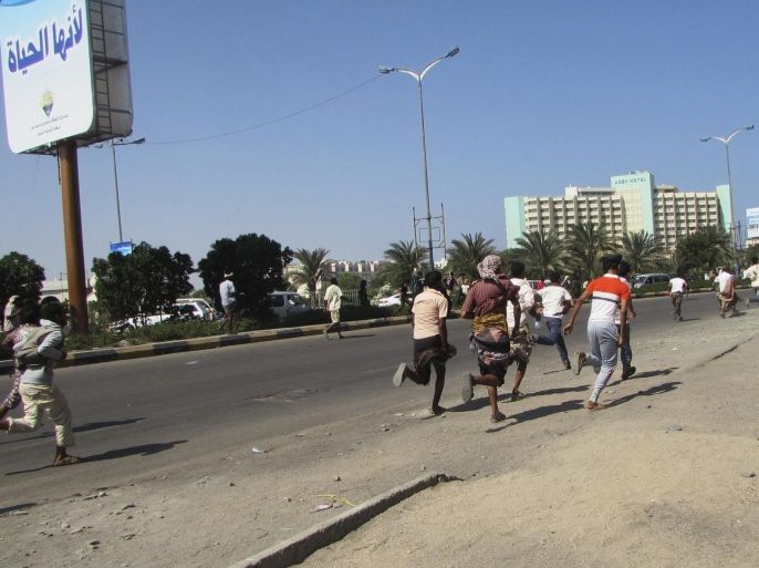 People flee after a gunfire on a street in the southern port city of Aden, Yemen, Wednesday, March 25, 2015. Yemeni President Abed Rabbo Mansour Hadi fled the country by sea Wednesday on a boat from Aden, as Shiite rebels and their allies advanced on the city where he had taken refuge. Aden was tense Wednesday, with schools, government offices, shops and restaurants largely closed. (AP Photo/Yassir Hassan)