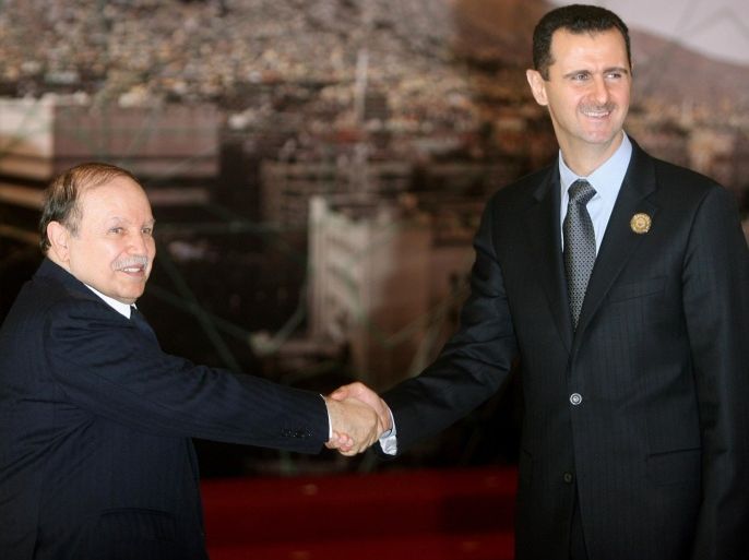 Syrian President Bashar al-Assad (R) shakes hands with his Algerian counterpart Abdelaziz Bouteflika at the opening session of the Arab Summit in Damascus on March 29, 2008. The Syrian President opened a boycott-hit Arab summit today in the absence of half of the region's leaders, many of whom blame Damascus for the political crisis in Lebanon.